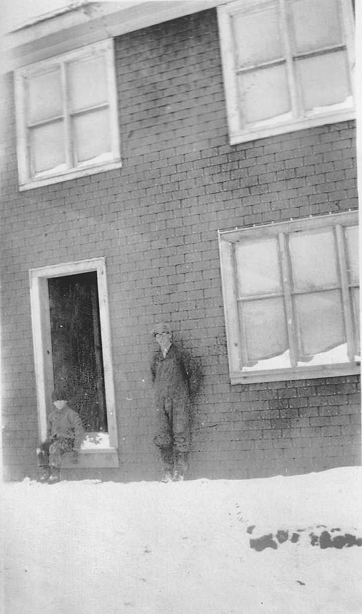 James Armstrong standing outside the house he built